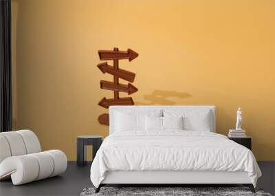 Plastic brown arrow signs on yellow gold luxury color background. Minimal design. Wall mural