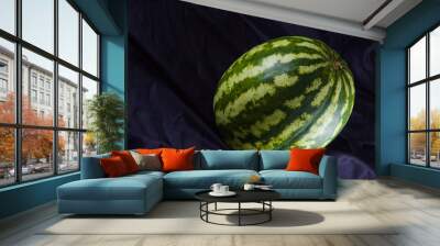 Watermelon on black cloth. Whole watermelon on dark background. Healthy food for vegan. Copy space Wall mural