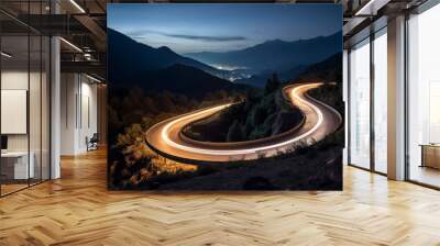 Aerial panoramic view of curvy mountain road with trailing lights at night. Winding road with car speed lights. Beautiful countryside landscape Wall mural