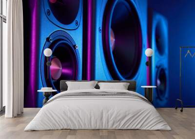 Multimedia acoustic sound speakers with neon lighting. Sound audio system with two satellites and subwoofer on dark background. Wall mural