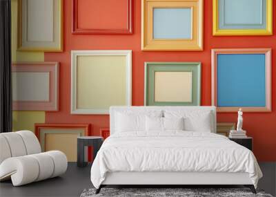 Pink wall with various empty colored frames. Design of apartment living room with blanks mock-up frames Wall mural