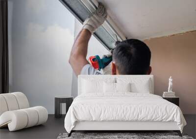 Process of man using screwdriver. Worker makes the installation of window Wall mural