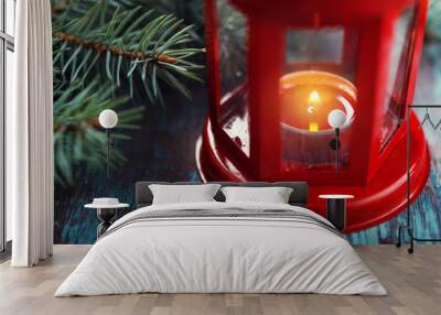 red lantern with a burning candle inside and a Christmas tree br Wall mural