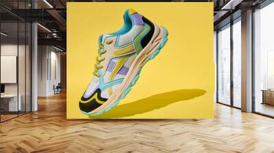 Single colorful sport sneaker with shadow against solid yellow background. Stylish fashionable minimalism concept. Flying shoes Wall mural