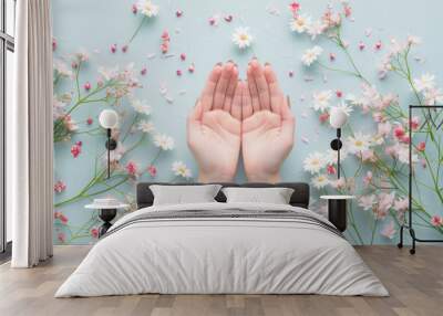 Woman hands among the spring flowers. Floral background with beautiful female hands. Natural cosmetics and skin care concept Wall mural