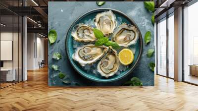 A plate of raw fresh oysters served on crushed ice with lemon wedges and fresh basil, ideal for seafood enthusiasts.. Wall mural