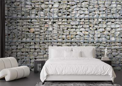 Abstract architectural background of rough retaining wall made from rocks in steel cage gabion baskets Wall mural