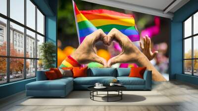 Hands making heart sign in front of rainbow flag Wall mural