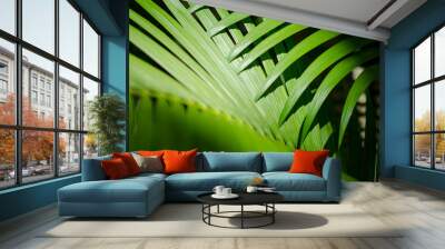 Jungle background of bright green palm fronds casting shadows in tropical sun Wall mural