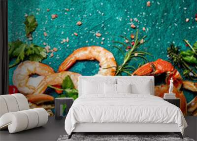 Fresh raw seafood - shrimps and crabs with herbs and spices on dark gray background. Copy space Wall mural