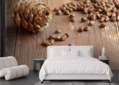 pine nuts and pine cones on a dark wooden background Wall mural