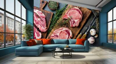 Raw pork cutlet chop for fry on grill and pan with herbs, garlic on wooden boards, slate gray background Wall mural