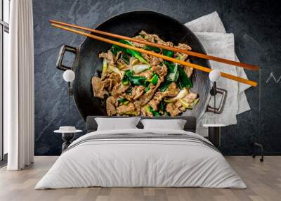 traditional chinese mongolian beef stir fry in chinese cast iron wok with cooking chopsticks, stone  Wall mural