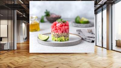 Tuna tartare tartar with avocado and quinoa. gourmet presentation with culinary ring on wite plate Wall mural