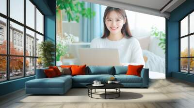 Asian woman using laptop computer. Wall mural