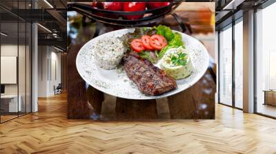 Beef steak with potatoes and rice in isolated white background Wall mural