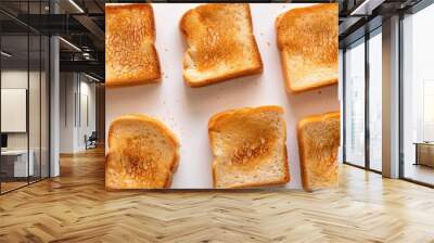 A close-up of toasted sliced bread on a white background, each piece showing a golden-brown crust and ready to enjoy Wall mural