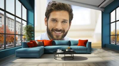 Portrait of handsome bearded man in office. looking at camera Wall mural