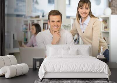 Portrait of smiling business team in office, looking camera Wall mural