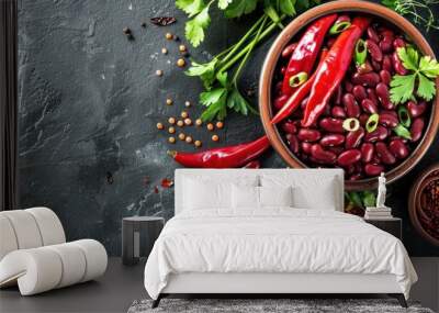 A bowl of chili with a variety of vegetables and spices on a black background Wall mural