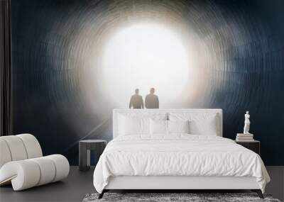 a surreal foggy corridor with a large circular opening in the wall two figures walk towards the light Wall mural