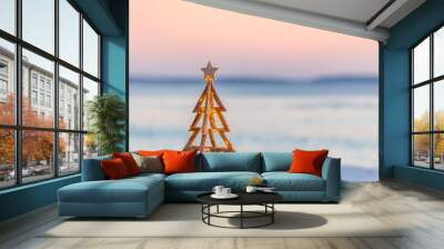 Christmas tree with fairy lights on the beach in summer Wall mural