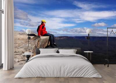 sitting on top of the world - hiker rests and admires views of b Wall mural