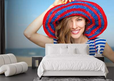 Beautiful woman in hat enjoying summer vacation with sea or ocean view Wall mural