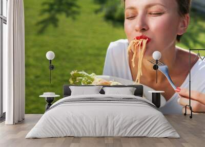 Young brunette woman eating spaghetti Wall mural