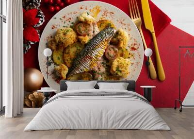 Baked mackerel with braised cauliflower and cherry tomatoes. Top view table with christmas decorations. Wall mural