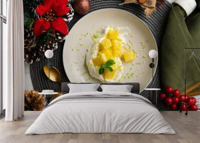 Delicious dessert with fresh pineapple and whipped cream on a table with Christmas decoration. Wall mural