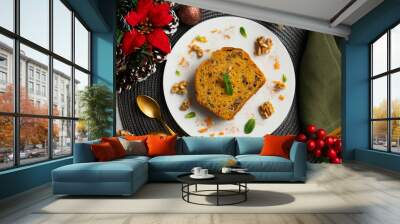 Delicious piece of carrot cake with walnuts on a table with christmas decorations. Wall mural