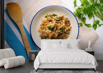 Rice paella with pork loin, mushrooms and broccoli. Top view table. Wall mural