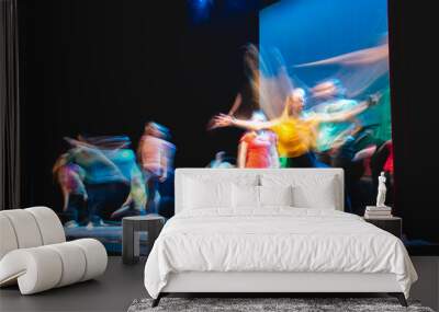 Group of dancer in colored clothes dancing on the stage in long exposure Wall mural