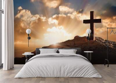 artistic easter greeting card featuring the cross on golgotha with radiant light rays emerging from behind clouds highlighting the significance of easter Wall mural