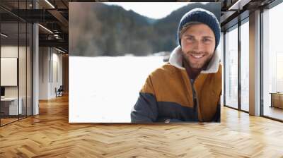 Portrait of smiling man in snow Wall mural