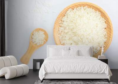 Heap of raw rice on wooden bowl and spoon Wall mural