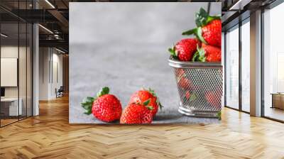 Photo of heap of fresh strawberries in the basket on rustic grey background..A bunch of ripe strawberries in a steel basket on the table. Copy space. Healthy fresh fruit. Organic food. Clear food Wall mural