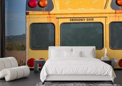 Rear view of an worn and faded school bus Wall mural