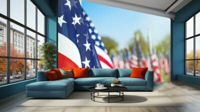 Closeup of an American flag in a row. Blue sky and flags in the background. Copy space.  Wall mural