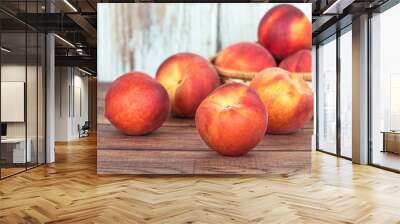 Closeup of peach fruits on wooden table Wall mural