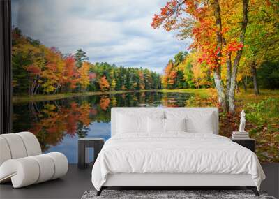 Fall foliage colors reflected in still lake water on a beautiful autumn day in New England Wall mural