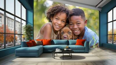 Portrait of an African American boy and girl sitting outdoors hugging their pet dog, looking at the camera and smiling. Wall mural