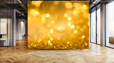 Abstract bokeh of glowing yellow lights and sparkling gold glitter background or wallpaper Wall mural