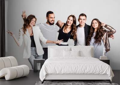 Company of young people dressed in stylish  casual clothes smile and have fun together  on a white background in the studio Wall mural