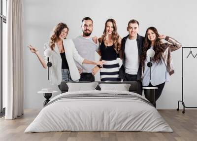 Company of young people dressed in stylish  casual clothes smile and have fun together  on a white background in the studio Wall mural