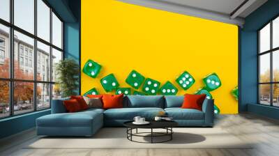 Green gaming dices on yellow background. Flat lay, place for text. Table games concept, board game for the whole family Wall mural