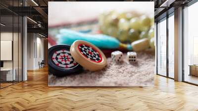 On a bright Mat are dice with numbers, a black and white patterned chip for backgammon and onyx rosary: a concept of Board games, macro, close up Wall mural