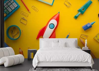 Blast off into the school year with a vibrant array of supplies—rocket-shaped pencil case, colorful pens, and all the essentials, set against a cheerful yellow backdrop. Wall mural