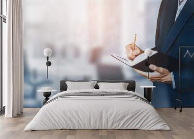 Asian businessman writing plan on book in meeting room Wall mural